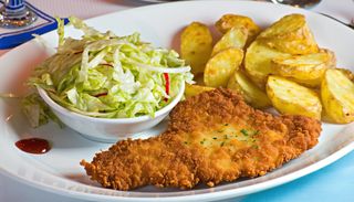 Snitel vienez de porc cu cartofi prajiti si salata de varza