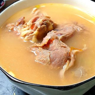 Boiled goat's meat served with local food 