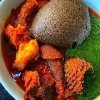 Amala served with ewedu mixed with shaki and pomo