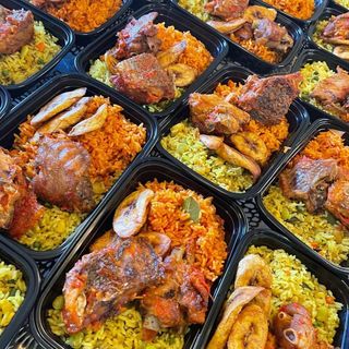Jollof Rice and Fried Rice served with plantains and chicken
