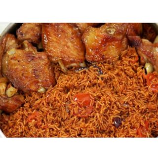 A Plate of Smoked Jollof Rice with Chicken, Turkey, and Hotdogs