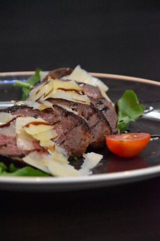 Tagliata from beefsteak, rocket salad, Grana Padano