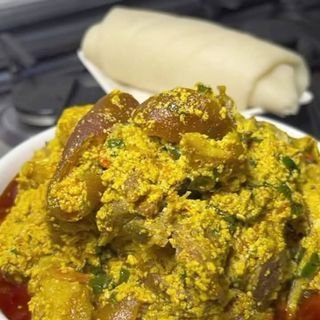 Pounded yam served with Egusi mixed with pomo 