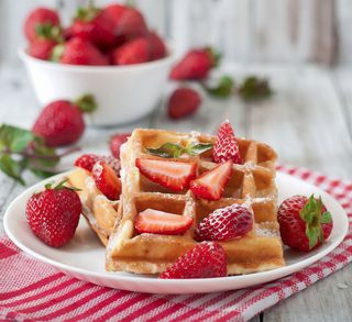 Waffle with strawberries and fresh cream