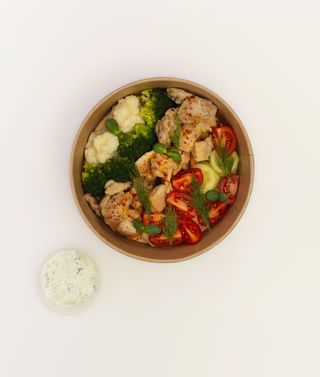 Bowl with souvlaki chicken thigh and baked potatoes