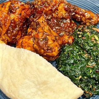 White ugali served with kuku kienyeji in Nigerian stew with sukuma 