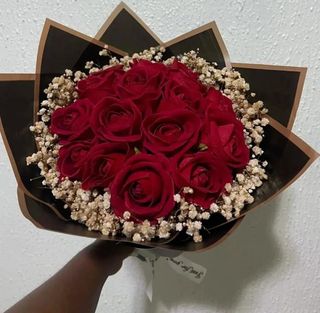 Dozen red roses with black wrapping