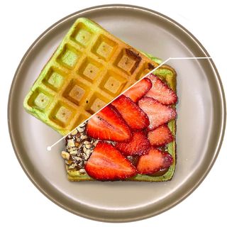 Spinach waffle with chocolate pasta, strawberries and peanuts
