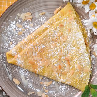 Crepe with condensed milk and almond petals