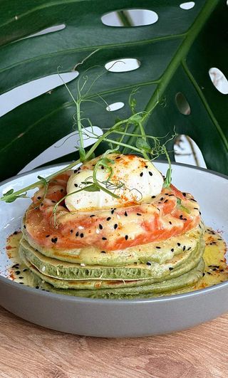 Spinach pancakes with salmon and poached egg and hollandaise sauce