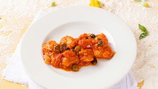Baccalà alla cirotana con pomodorini e olive taggiasche