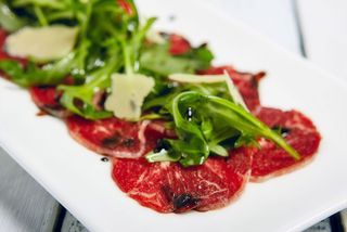 Carpaccio de res con rúcula y parmesano
