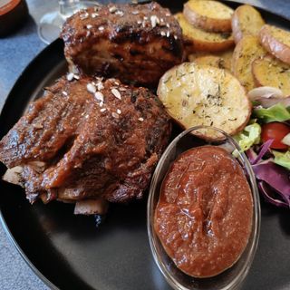 Costite de porc gratinate cu sos BBQ si cartofi la cuptor