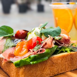 Big toast with prosciutto Crudo, backed tomatoes, grilled eggplant