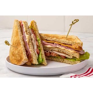 Club Sandwich (Bacon, Eggs, Cheese, Fried Onions & Brown Bread) All Sandwiches served with Fries