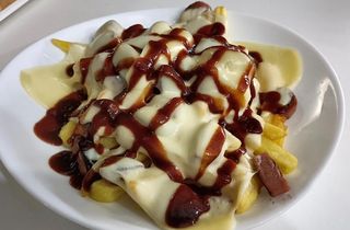 Patatine fritte con würstel e formaggio