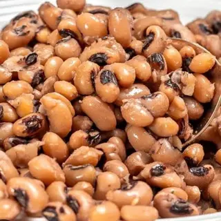 Boiled Red oloyin beans mixed with spicy Nigerian stew