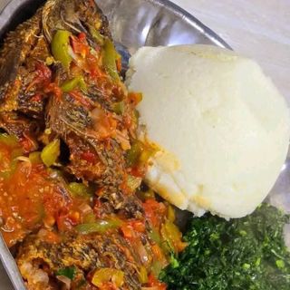 White ugali served with tilapia fish and sukuma