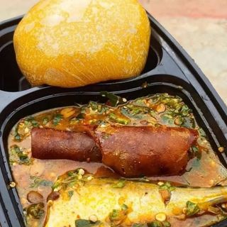 Yellow Eba served with okro mixed with Titus fish and pomo