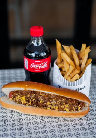 Mighty chili hot dog with chips and soda