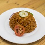 PUZZLE COAL- POT JOLLOF RICE  WITH FRIED FISH AND PLANTAIN 