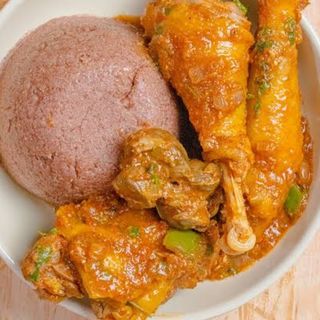 Brown ugali served with kuku kienyeji in Nigerian stew