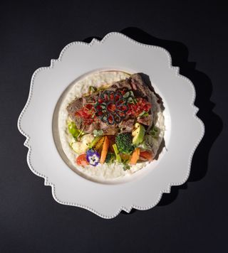 Ribeye steak with champagne risotto and vegetables 