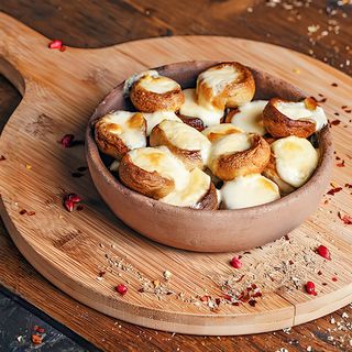MUSHROOM WITH CHEESE IN A CLAY POT
