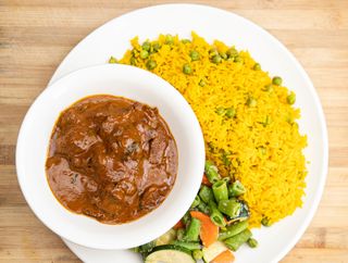 Swahili Beef Stew With fried mchicha and seasoned vegetables.