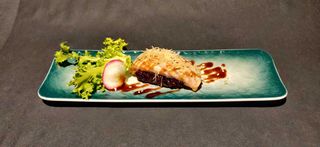 208. Black salmone flambè