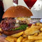 Grilled Chicken and cheese burger served with fries and a soda 