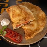Cheburek with chicken and tomatoes.