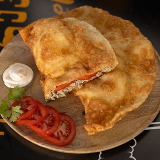Cheburek with chicken and tomatoes.