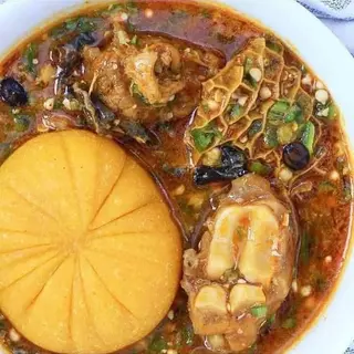 Yellow Eba served with okro mixed with shaki and cowlegs 
