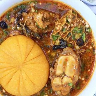 Yellow Eba served with okro mixed with shaki and cowlegs 