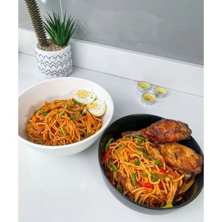 Jollof Spaghetti With Salad, Plantain, & Chicken Drumstick