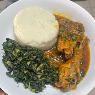 White ugali served with kuku kienyeji and kunde