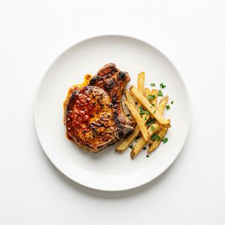 Chuleta De Cerdo Adobada Con Papas Fritas Naturales