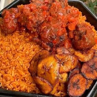 Jollof rice with deep fried plantains and chicken drumstick