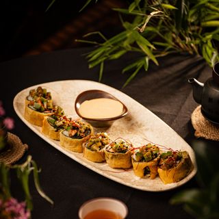 Hot roll with salmon and spicy nut sauce