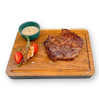 Стейк рібай з трюфельним соусом та печеним часником (300/30 г)