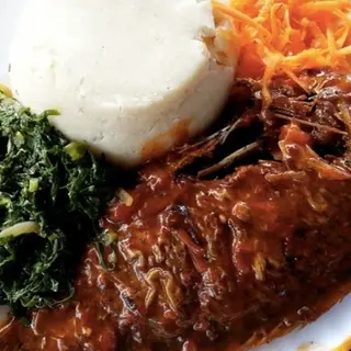 White ugali served with fish in Nigerian stew with sukuma 