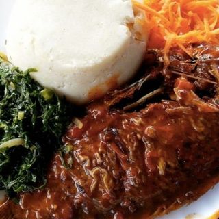 White ugali served with fish in Nigerian stew with sukuma 