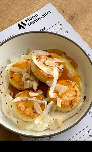 Syrniki with sour cream and mango-maracuja