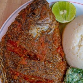 Semolina served with tilapia fish and spinach in cream
