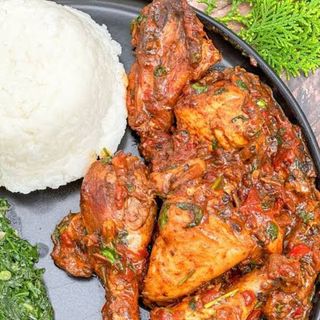 White ugali served with kuku kienyeji and spinach 
