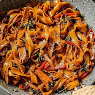 Vegetable fried flat noodles with mushroom and tufo.