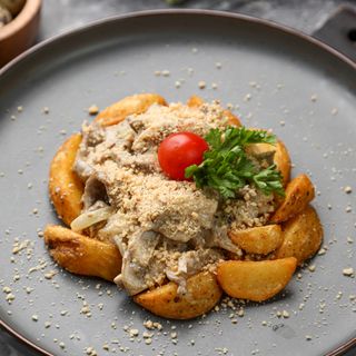 Говядина в сливочном соусе с грибами под арахисовой крошкой