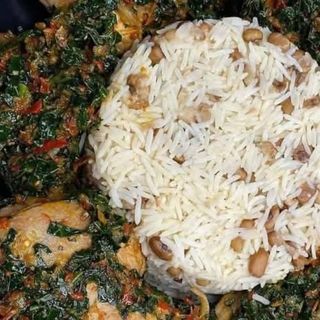 Nigerian beans mixed with white rice served with vegetable pomo