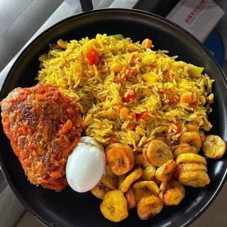 Jollof rice, plantains, chicken and boiled egg